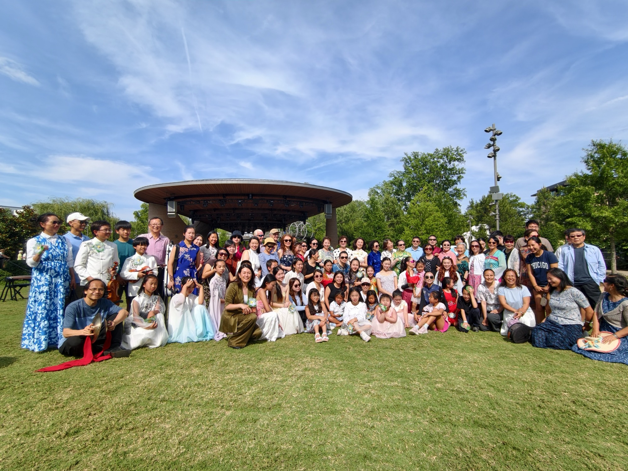 NCAAA members and families, many in traditional dress, gathered on the lawn at Downtown Cary Park